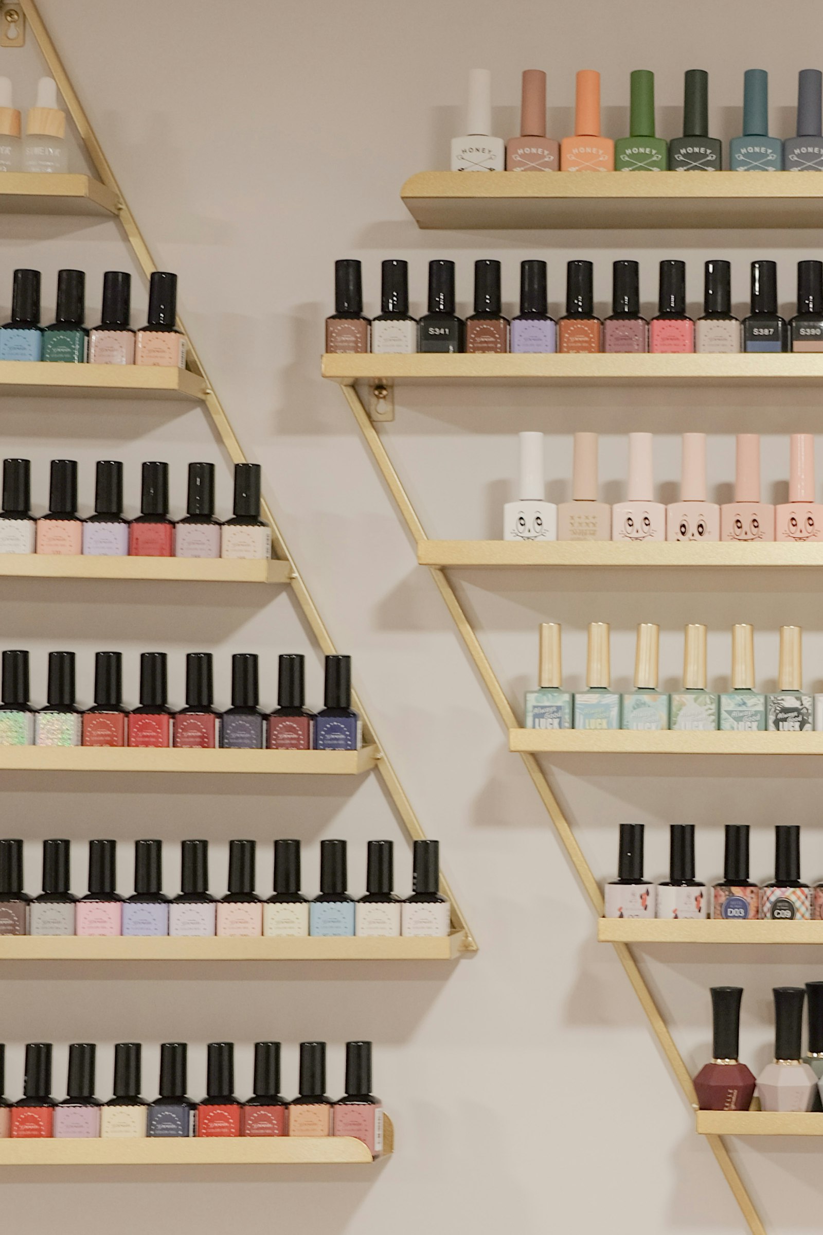 Nail polish collection on gold shelves